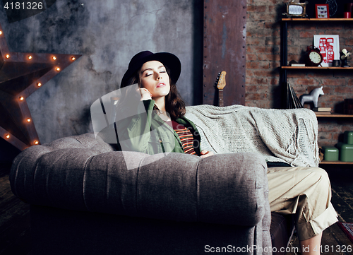 Image of young pretty woman waiting alone in modern loft studio, fashion musician concept, lifestyle people