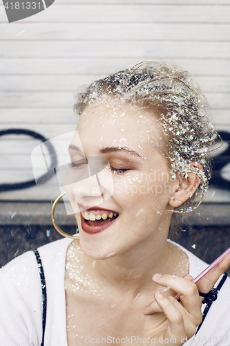 Image of young pretty party girl smiling covered with glitter tinsel, fashion dress, stylish make up, lifestyle people concept close up