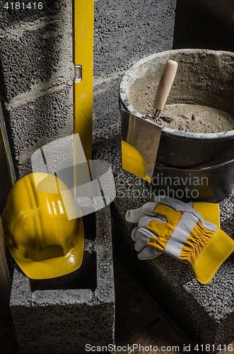 Image of Tools for bricklayer bucket with a solution and a trowel, close-