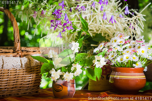 Image of Buns in a wicker basket and a bouquet of flowers