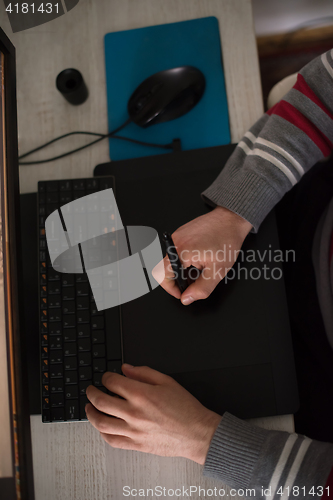 Image of graphic designer at work top view