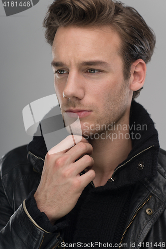 Image of portrait of a young guy over gray background