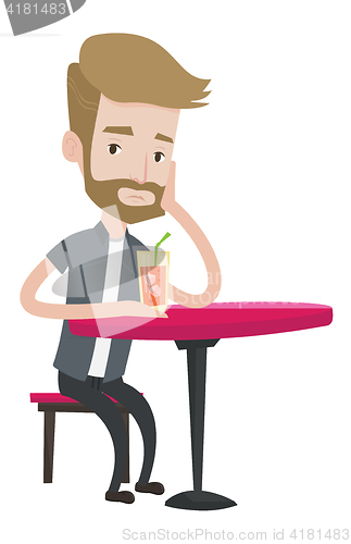 Image of Man drinking cocktail at the bar.