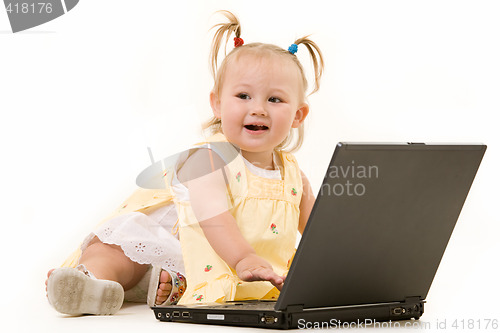 Image of Adorable baby with laptop