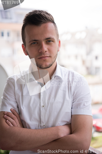 Image of man standing at balcony