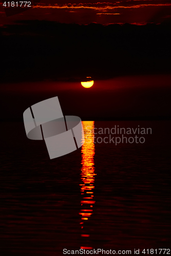 Image of Sunrise in the sea with soft wave and cloudy