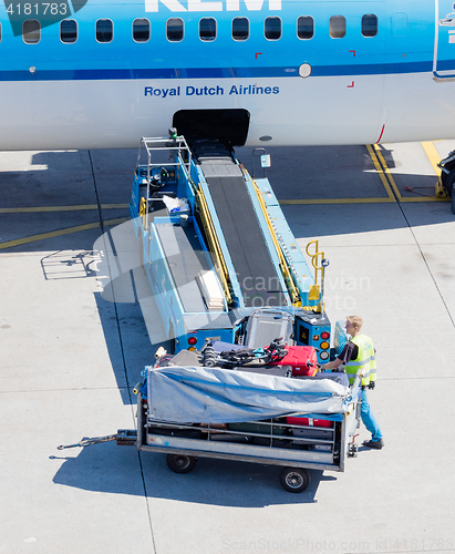 Image of AMSTERDAM, NETHERLANDS - AUGUST 17, 2016: Loading luggage in air