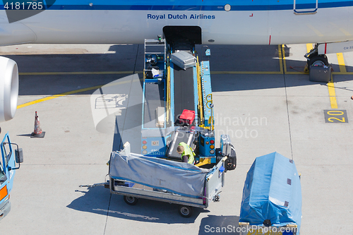 Image of AMSTERDAM, NETHERLANDS - AUGUST 17, 2016: Loading luggage in air