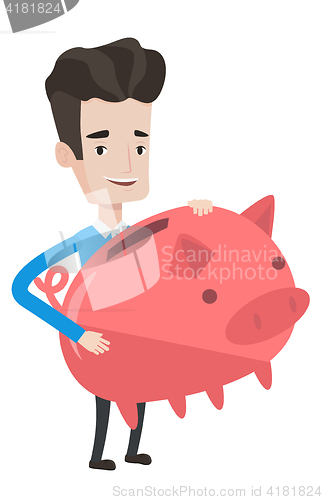 Image of Businessman holding a big piggy bank.