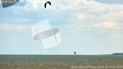 Image of Athletic man jump on kite surf board