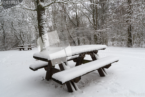 Image of Snow covered benches and tables