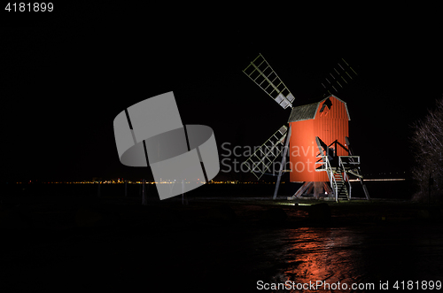 Image of Red old traditional windmill by night