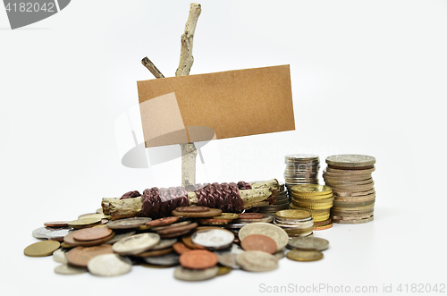 Image of Paper sign board with stack of coins