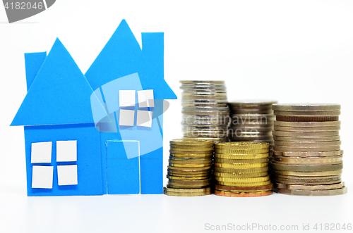 Image of House model and stacks of coins