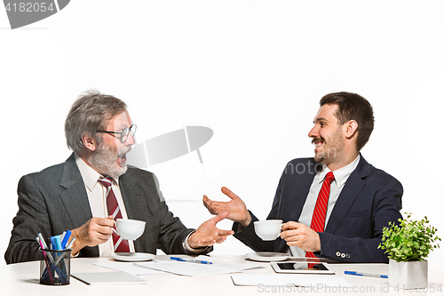 Image of The two colleagues working together at office on white background.