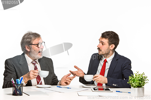 Image of The two colleagues working together at office on white background.