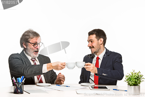 Image of The two colleagues working together at office on white background.