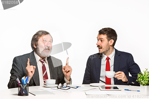 Image of The two colleagues working together at office on white background.