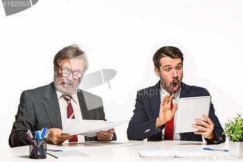 Image of The two colleagues working together at office on white background.