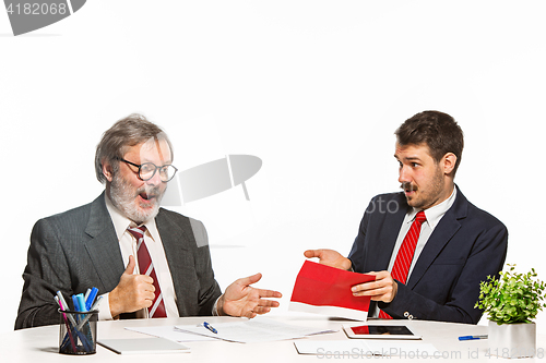 Image of Concept - corruption. Businessman in a suit taking a bribe