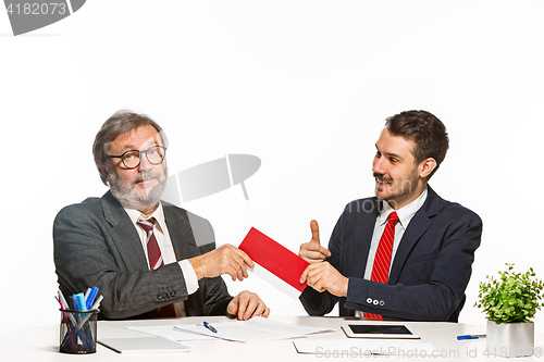 Image of Concept - corruption. Businessman in a suit taking a bribe