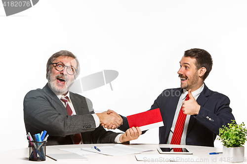 Image of Concept - corruption. Businessman in a suit taking a bribe