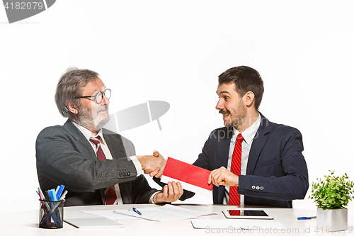 Image of Concept - corruption. Businessman in a suit taking a bribe