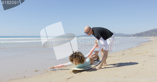Image of The instructor with female surfer