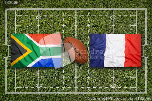 Image of South Africa vs. France flags on rugby field