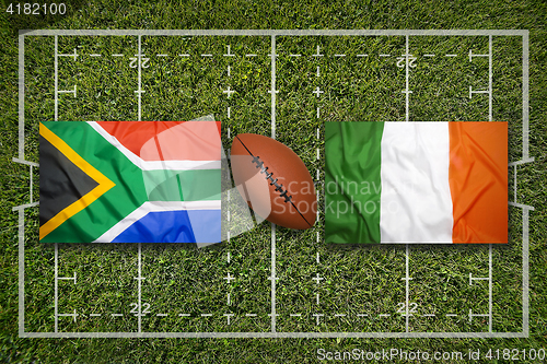 Image of South Africa vs. Ireland flags on rugby field