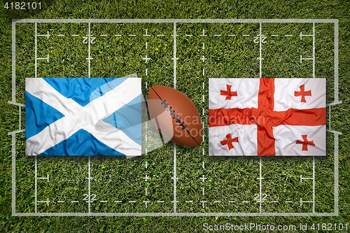 Image of Scotland vs. Georgia flags on rugby field