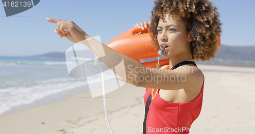 Image of Lifeguard blowing a whistle on beach