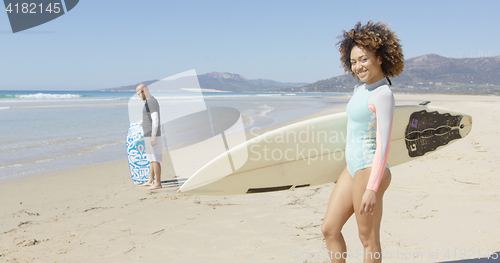 Image of Female holding surfboard on beautiful beach background