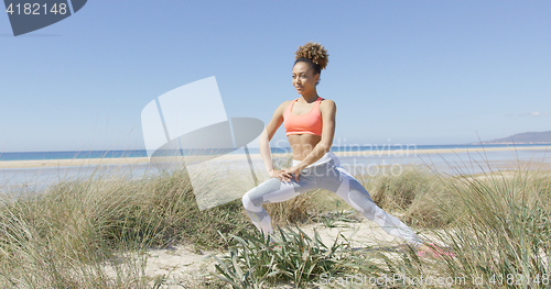 Image of Woman warmin up on the beach