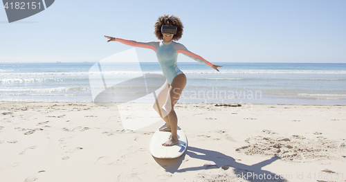 Image of Female wearing virtual reality glasses on beach