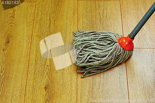 Image of washing wood floor with wet mop