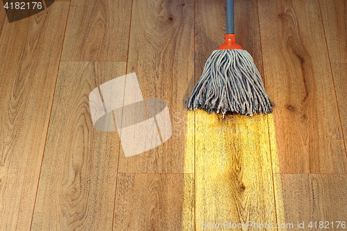 Image of cleaning wooden floor with a mop