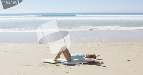 Image of Young woman on a surfboard