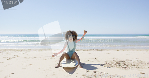 Image of Female on beach wearing virtual reality glasses