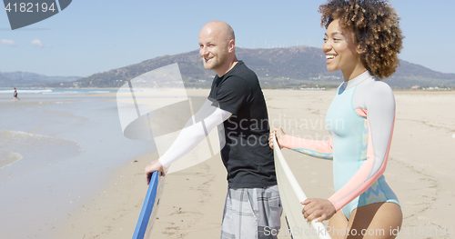 Image of Cheerful surfers on a beach