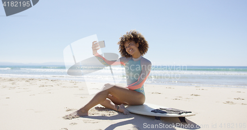 Image of Female taking selfie on beach