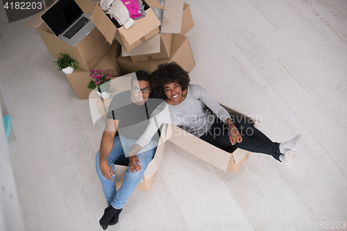 Image of African American couple  playing with packing material