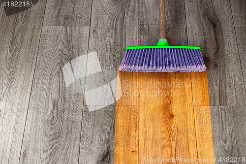 Image of sweeping out wooden parquet