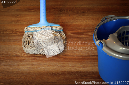 Image of cleaning equipment on wooden floor