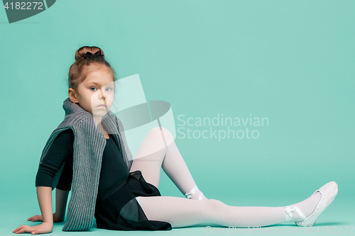 Image of The little balerina dancer on blue background