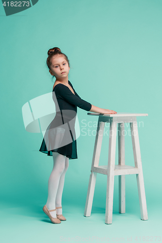 Image of The little balerina dancer on blue background