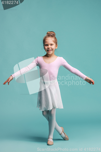 Image of The little balerina dancer on blue background