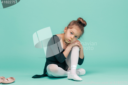 Image of The little balerina dancer on blue background