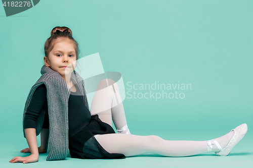 Image of The little balerina dancer on blue background