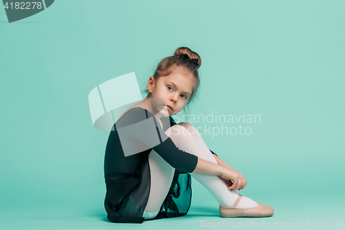 Image of The little balerina dancer on blue background